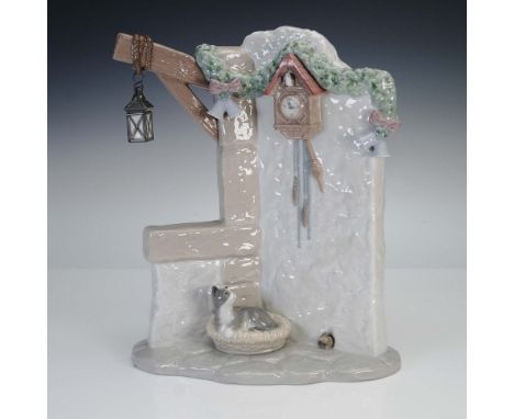 Glazed finish figure part of Santa's Magical Workshop collection. Depicts a rustic snow covered wall adorned with a hanging l