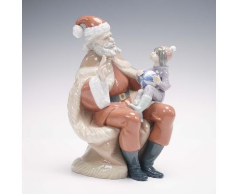 Lladro's A Christmas Wish (#01005711), sculpted by Juan Huerta, captures a tender holiday moment with a young child holding a