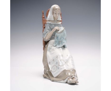 This elegant LladrÃ³ porcelain figurine, titled "Embroiderer" (model #01004865), depicts a serene woman engrossed in embroide