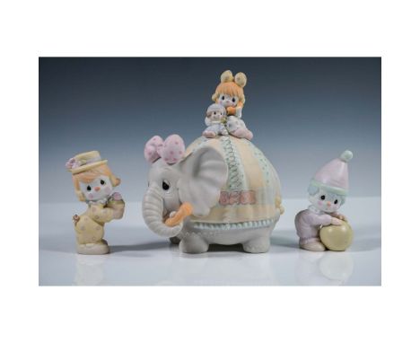 Three-piece Precious Moments ceramic figurine set featuring a pastel circus theme. The centerpiece is a musical elephant titl