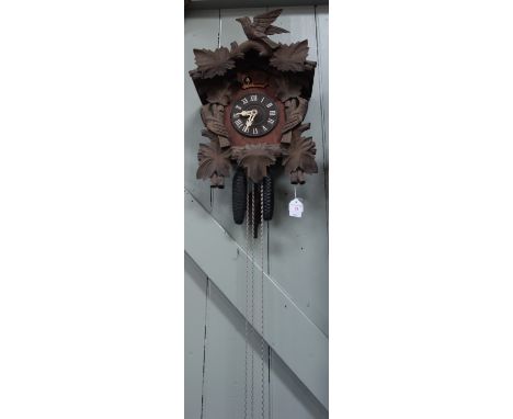 A 20TH CENTURY BLACK FOREST THREE TRAIN CUCKOO AND QUAIL CLOCK (back door and gong missing)