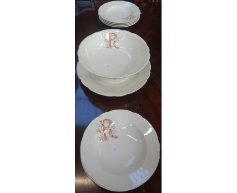 A FRENCH PART CREAM POTTERY DINNER SERVICE with transfer printed monogram 'R B', comprising footed bowl, charger and eight so