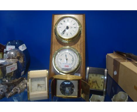 THREE VINTAGE TRAVEL CLOCKS, a compass and a brass cased clock with matching barometer