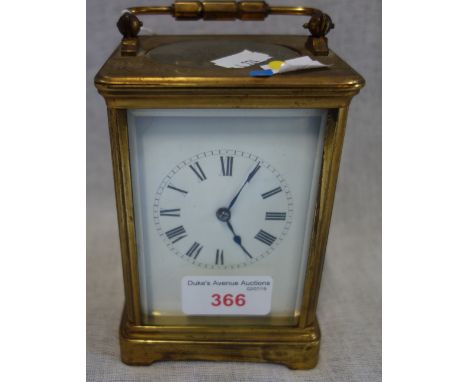 A FRENCH BRASS CASED STRIKING CARRIAGE CLOCK, the white enamel dial with Roman numerals, the eight day movement striking on a