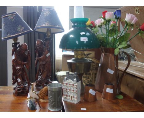 A PAIR OF CHINESE CARVED HARDWOOD FIGURES fitted as lamps, an oil lamp, a copper jug and other items