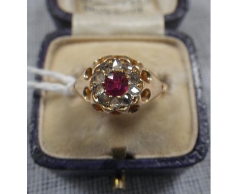 A 'RUBY' AND DIAMOND DRESS RING, on an 18ct yellow gold shank, ring size J