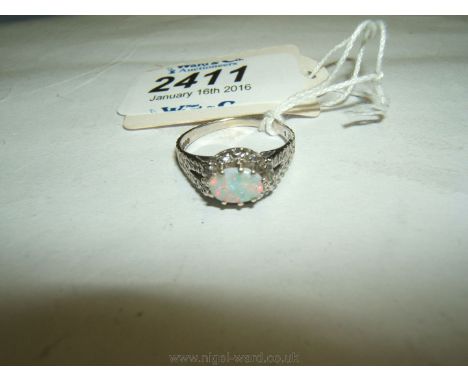 A 9ct White Gold Bark Effect Floral Ring with Central Oval Opal & Surrounding Diamonds.