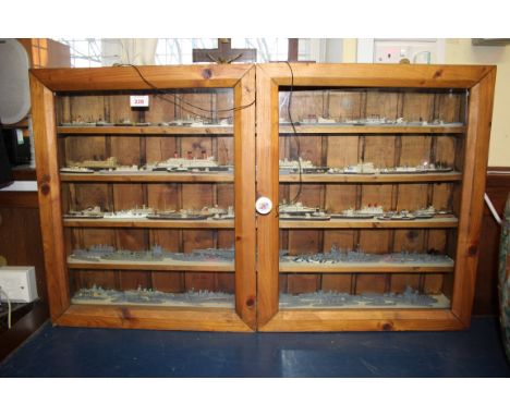 A display case containing approximately 120 wooden 1000-1 scale models, of maritime and naval vessels.