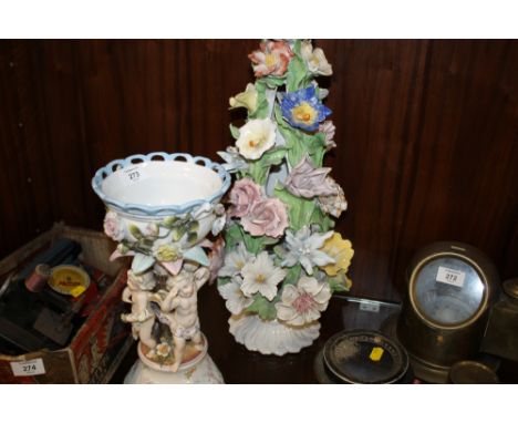 A CONTINENTAL CHERUBIC CERAMIC CENTREPIECE TOGETHER WITH A FLORAL EXAMPLE 