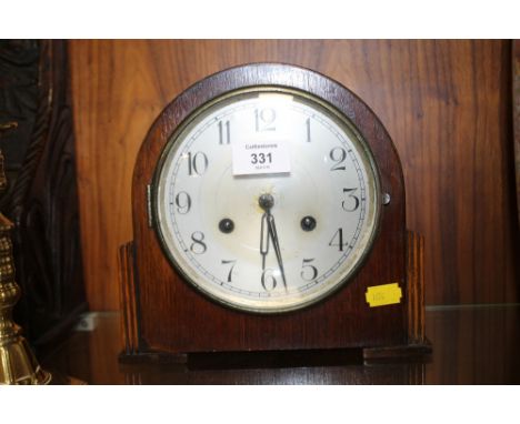 A VINTAGE OAK MANTLE CLOCK