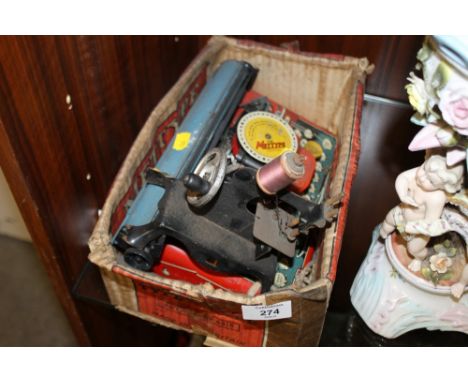 A VINTAGE METTYPE JUNIOR TINPLATE TYPEWRITER TOGETHER WITH A MINIATURE SEWING MACHINE 