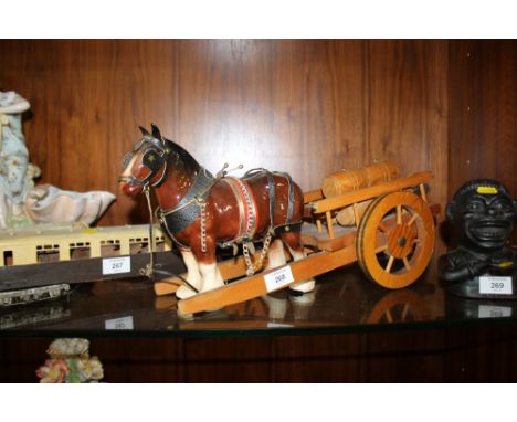 A CERAMIC HORSE AND CART FIGURE 