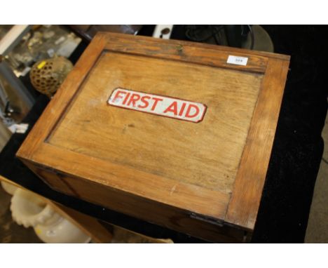 A VINTAGE WOODEN FIRST AID CABINET AND CONTENTS