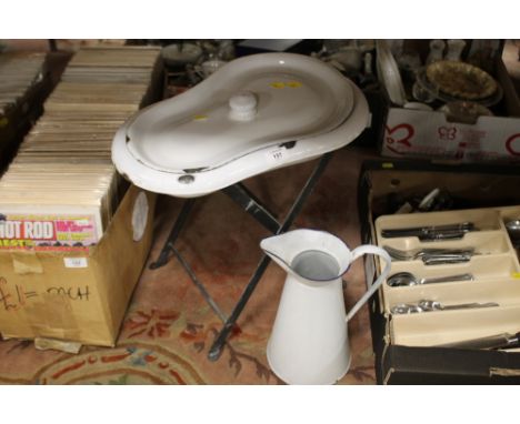 AN ENAMEL BASIN ON STAND AND JUG
