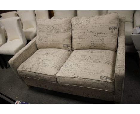 A MODERN 2 SEATER UPHOLSTERED SOFA WITH SCRIPT DETAIL