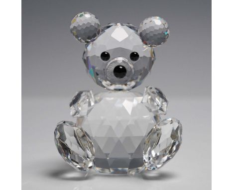 A charming Swarovski Silver Crystal figurine of a small seated bear, crafted with faceted clear crystal and finished with jet