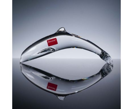 This Baccarat crystal dolphin figurine gracefully captures the fluid motion of a dolphin mid-leap, rendered in brilliant clea
