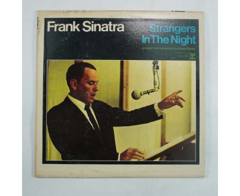 This is a vintage Frank Sinatra vinyl record titled Strangers in the Night, released by Reprise Records. This album features 