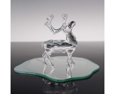 Swarovski crystal figurine, model 214821, features a beautifully crafted reindeer made from clear, faceted crystal, capturing