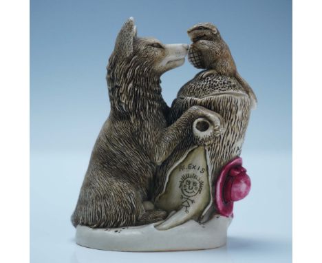 This figural box features a wolf and a beaver engaged in a symbolic interaction, with the wolf's paw resting against a tree s
