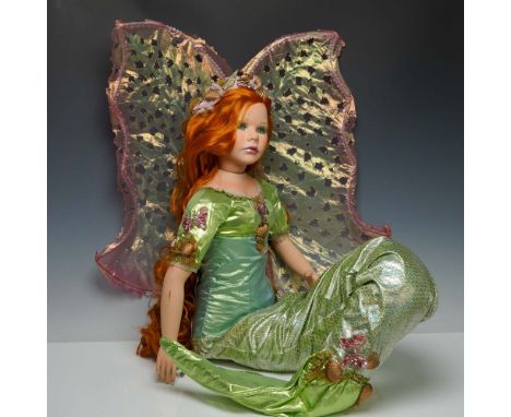 This striking porcelain fantasy doll by Show-Stoppers features a captivating mermaid-fairy design with long red hair and expr