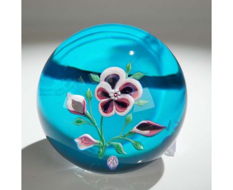 Crafted by the prestigious French crystal maker Baccarat, this paperweight showcases a central pansy flower with detailed pet