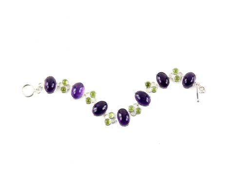 Amethyst and peridot bracelet, seven oval cabochon cut amethysts, measuring an average 13.5 x 9.5mm, each separated by two ro