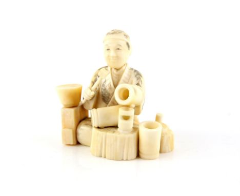 A Japanese Okimono , Meiji Period Circa 1880 Carved Ivory representing a sitting man working with an hammer in his hand . Sig