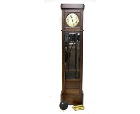 1920s oak longcase clock, the silvered dial with Arabic numerals over a bevelled glazed door and plinth base, the twin train 