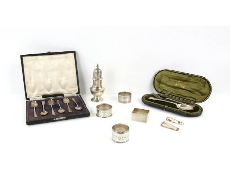 Silver sugar sifter, four napkin rings, two money clips, set of six tea spoons, cased, and a cased spoon and fork