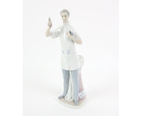 Lladro Figure of a dentist, holding up a tooth with pliers, H36 cm 