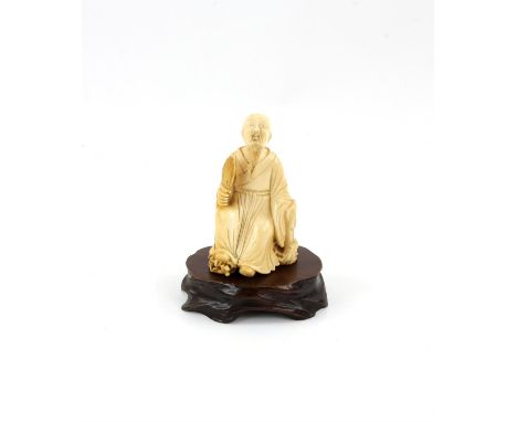 A Japanese Okimono , Meiji Period Carved Ivory representing a a sitting man. with wood stand . 8.4 X 5..6 cm, Comes with a Du