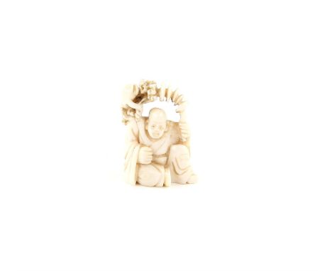 A Japanese Netsuke , Meiji Period Carved Ivory representing a man with a frog. 5.3 X 3.6 cm, Comes with a Dutch certificate o