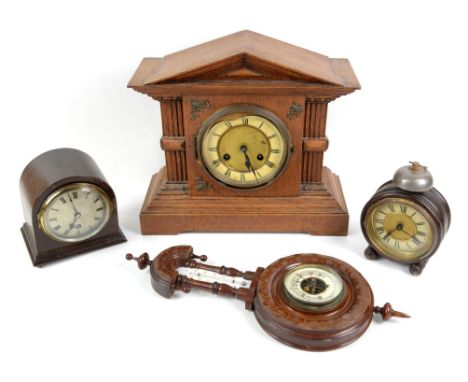An early 20th century oak architectural form mantel clock, H33 cm, a barrel shaped clock, H18 cm, an arched clock and an aner