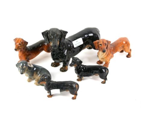 Royal Copenhagen figure of a dachshund (3140), four other similar Royal Doulton figures including HN1127 'Shrewd Saint' and a