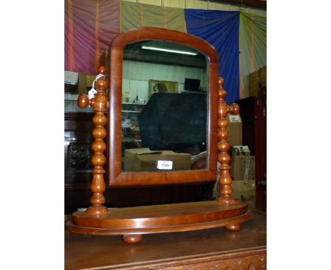 A 19th century light mahogany swing mirror with bobbin turned supports and pill feet, 20" x 20".