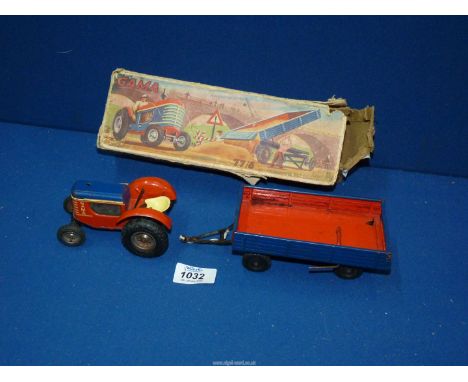 A boxed Gama 77/6 clockwork tractor and tipper trailer, made in Western Germany.