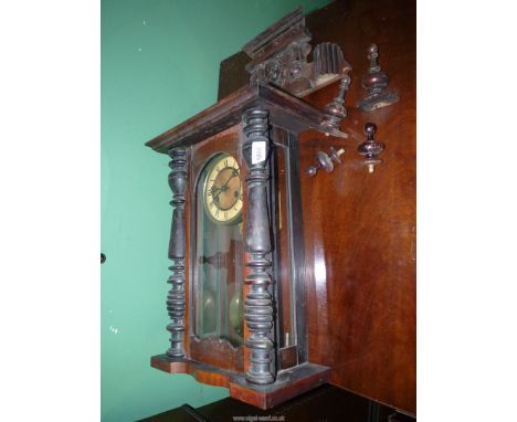 A two-train spring-driven movement Vienna style Wall clock with Roman numerals. 28" high, 14" wide. Key and pendulum present,