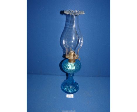A blue glass oil lamp with fluted chimney, 17" tall.