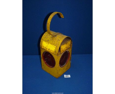 A 'Chalwyn' railway lamp, painted yellow.
