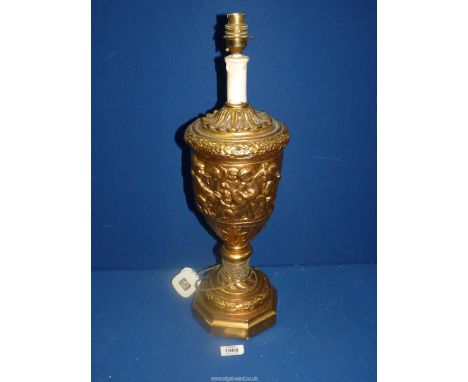 A gilt lamp base with moulded cherub decoration in classical style, 20 1/2'' high.