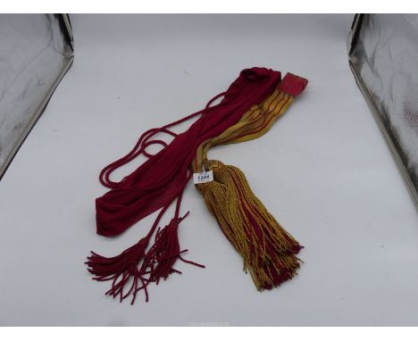 An Officer's scarlet Military sash and a ceremonial Officer's sash/waist belt, gold with three maroon stripes and gold and ma