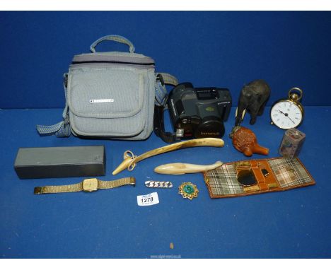 A box of music including a shoe horn, small Quartz battery clock, camera, Ronson lighter, cased nail set, elephant, wooden pi