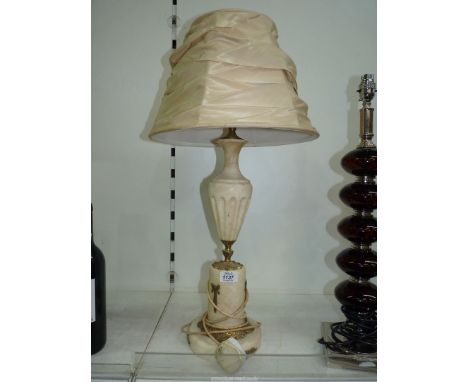 A white marble lamp base with brass details and cream shade, 26" tall.