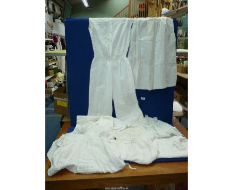 A quantity of vintage cotton and lace undergarments and gowns to include lady's 'one piece' and a pair of bloomers, children'