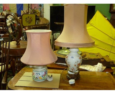 A Poole Pottery table lamp and a floral table lamp, both with pink shades, 17" and 25" tall including shades.