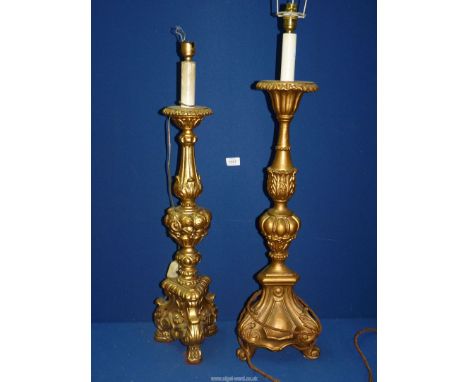 Two moulded gilt Torchere/lamp bases, one on scroll feet, the other with moulded fruit decoration on paw feet, 32 1/2'' and 2