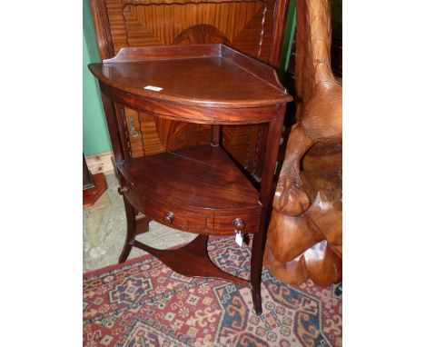 A Georgian Mahogany corner Washstand having a frieze drawer, the lower legs being united by a shaped shelf, 22 3/4'' wide x 3