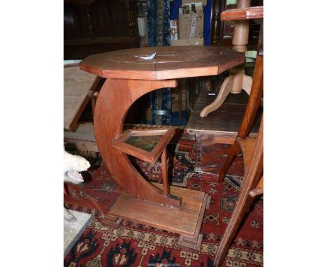 An unusual arts and crafts occasional Table having an oval ten sided crossbanded top, a crescent shaped swept support featuri