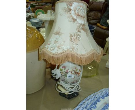 A pretty china lamp base in white ground with birds and floral pattern comes with floral fringed shade, 20'' tall including s
